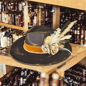 Black and Gold Wide Brim Hat with Feather and Flower Accents